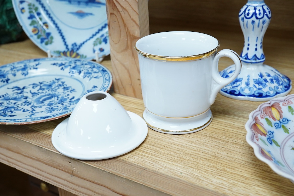 An 18th century Delft plate, two tin-glazed dishes and candlestick, a Gardener Russian porcelain tea cup and saucer, and a mug with liner, largest 22cm in diameter